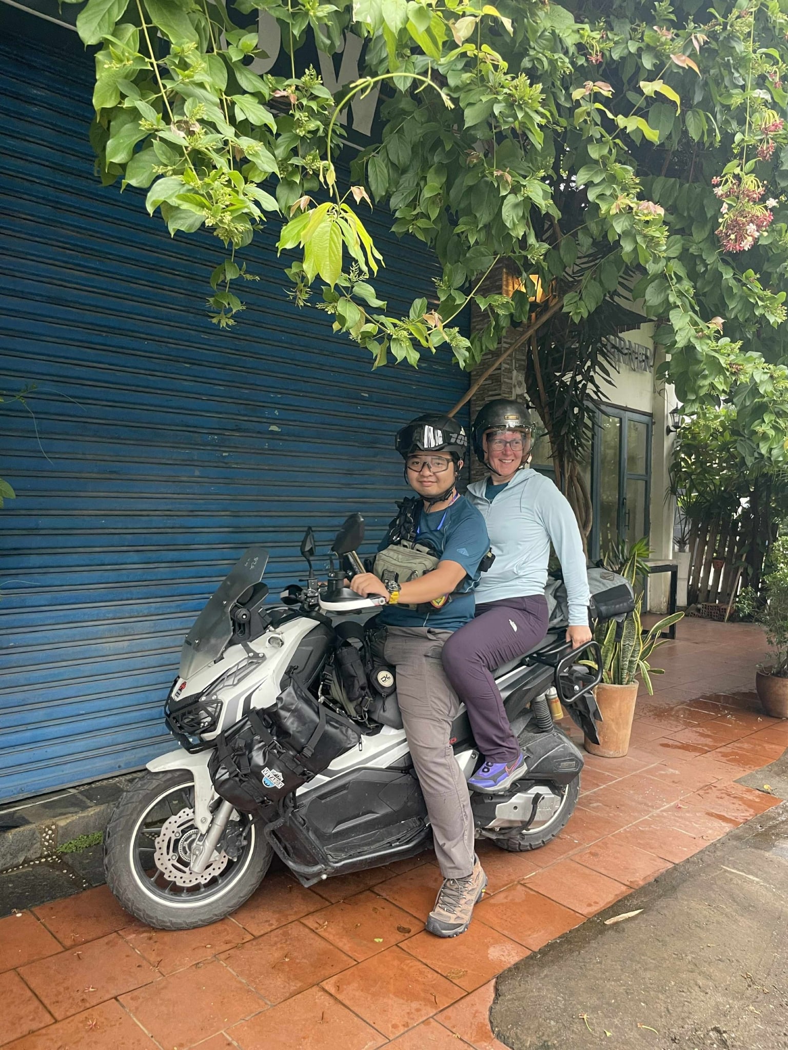Solo traveler riding with a local guide on a Saigon motorbike tour