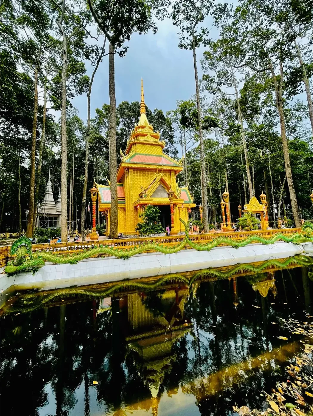 Khmer pagoda reflected in a pond in Tra Vinh, Mekong Delta