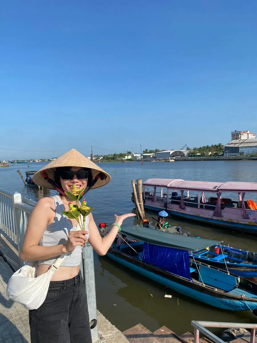 Tien, co-founder of Trip Chip Travel, at a Mekong river pier
